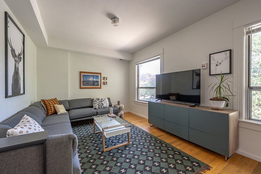 living room with large sectional sofa and smart tv