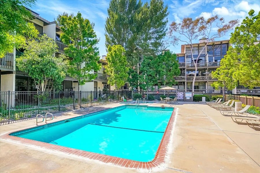Guests can enjoy access to a large outdoor swimming pool surrounded by a spacious pool deck and lounge chairs.