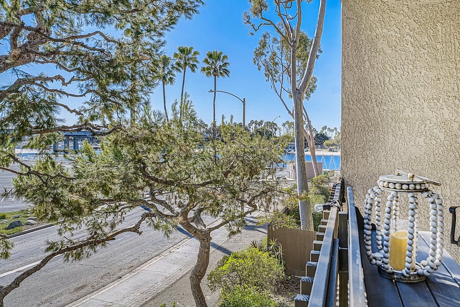 From the balcony, guests can enjoy views toward the surrounding neighborhood, mature trees, and nearby waterfront areas.