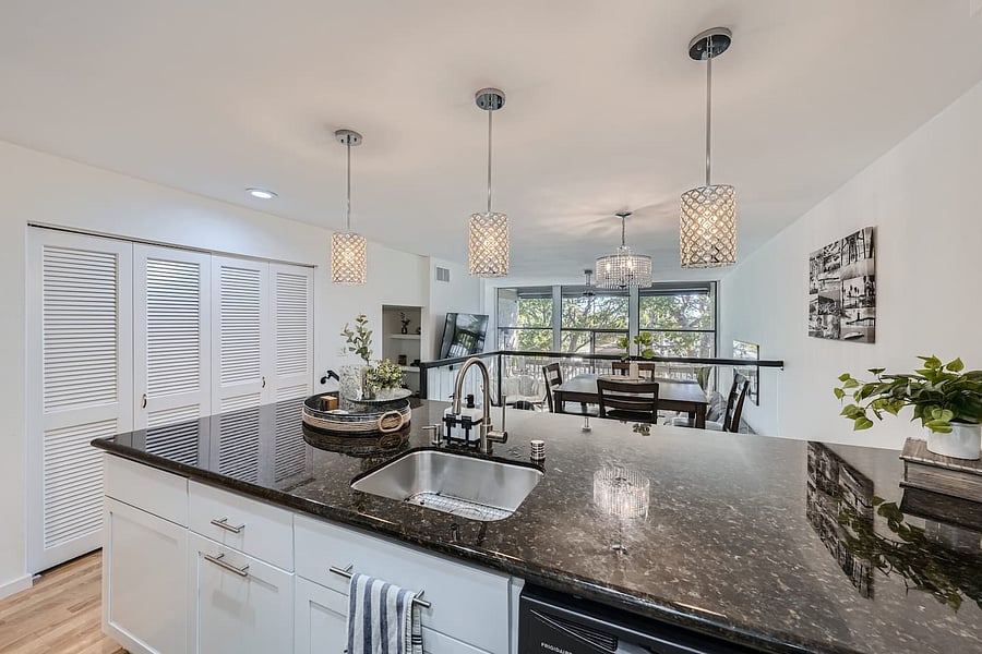 The oversized kitchen island provides generous counter space along with seating for four, perfect for casual dining or gathering while preparing meals.