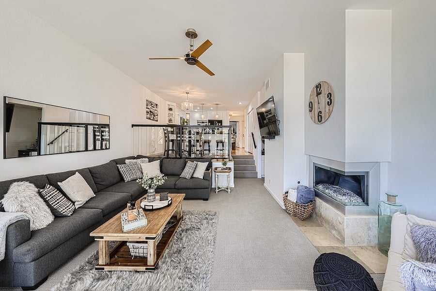 The spacious living room features a large sectional, plush area rug, coffee table, accent seating, and plenty of room for guests to gather.