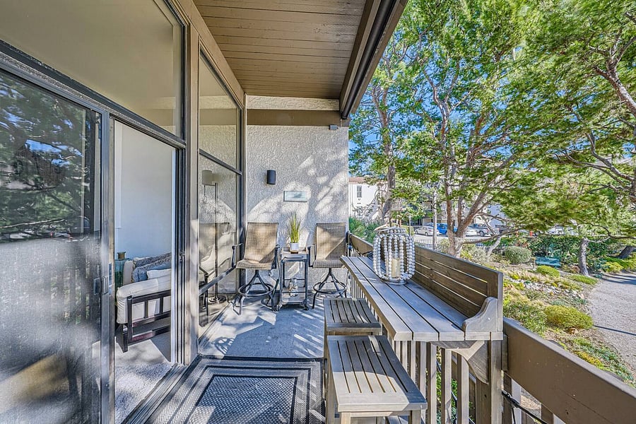 Large sliding glass doors provide direct access to the balcony and bring the outdoor surroundings into the living area.