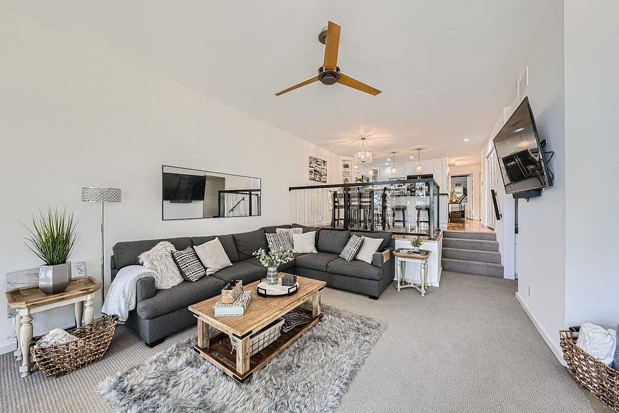 The living room, dining area, and kitchen flow seamlessly together, creating a spacious and social environment.