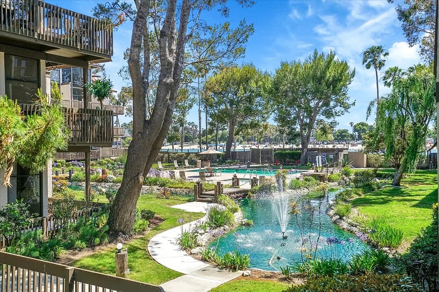 A picturesque landscaped lagoon with fountains winds through the community, creating a tranquil and resort-like atmosphere.