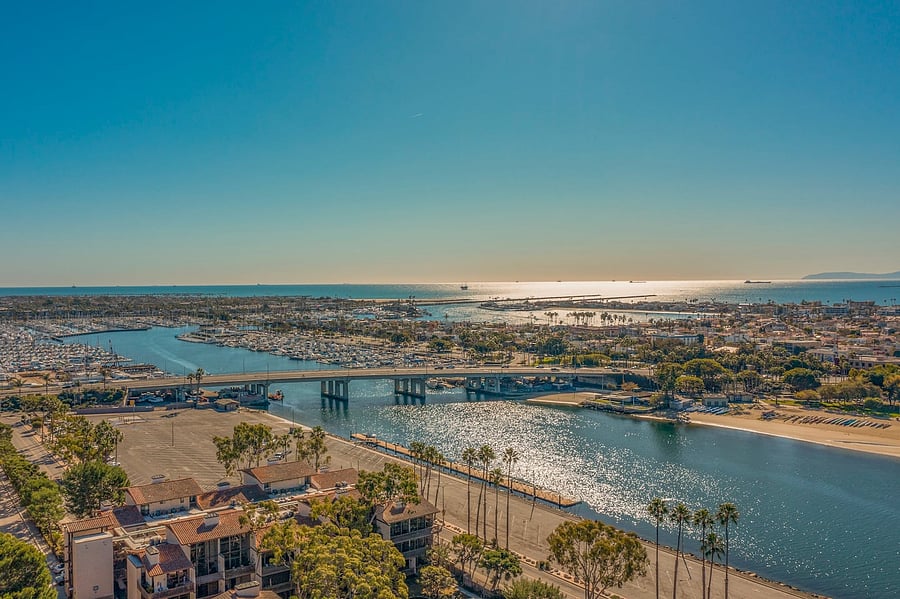 The community is situated near the water, with scenic views of the marina, waterways, and surrounding coastal landscape.