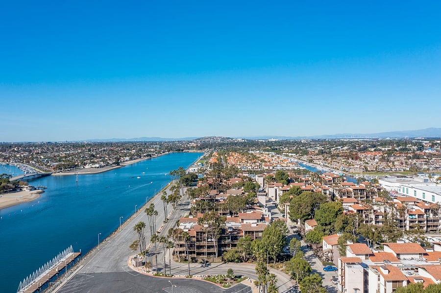 Tall palm trees, blue skies, waterways, and lush landscaping