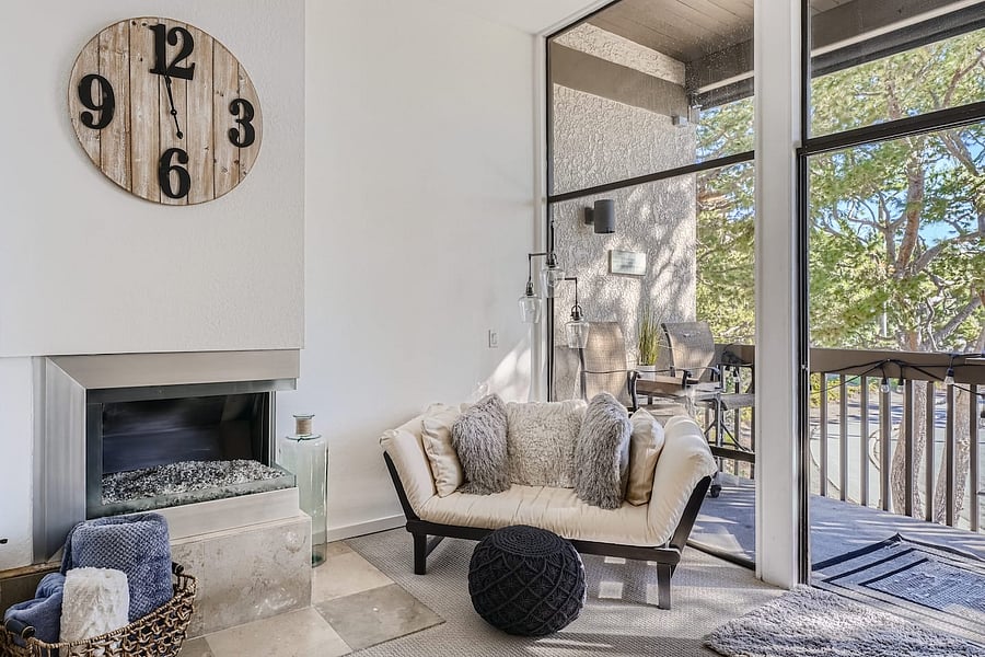 A comfortable seating nook beside the fireplace offers a relaxing spot to curl up with a book or enjoy a quiet evening.