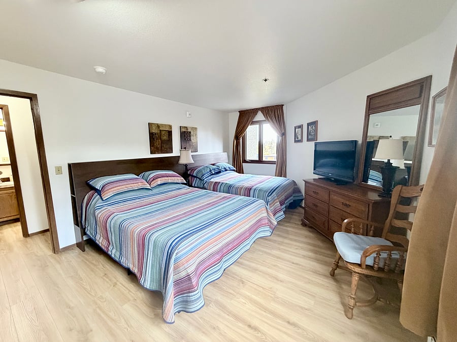     Comfortable second bedroom with queen and full beds, ideal for families or traveling companions.