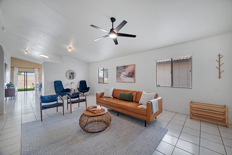Bright, welcoming living room with comfortable seating and a large Roku Smart TV-ideal for relaxing after work or spending time together.