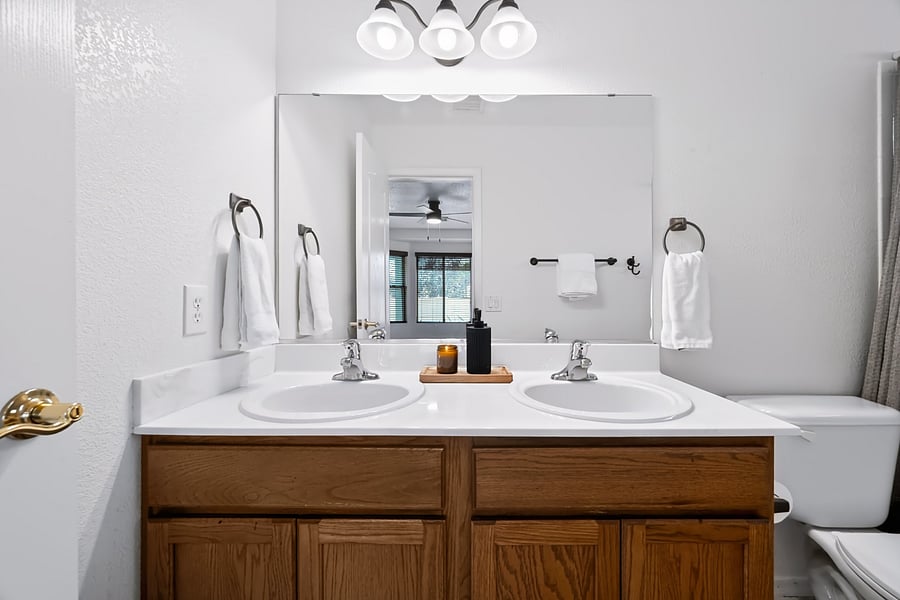 Private primary ensuite bathroom with double vanity, offering convenient personal space and storage for extended stays.