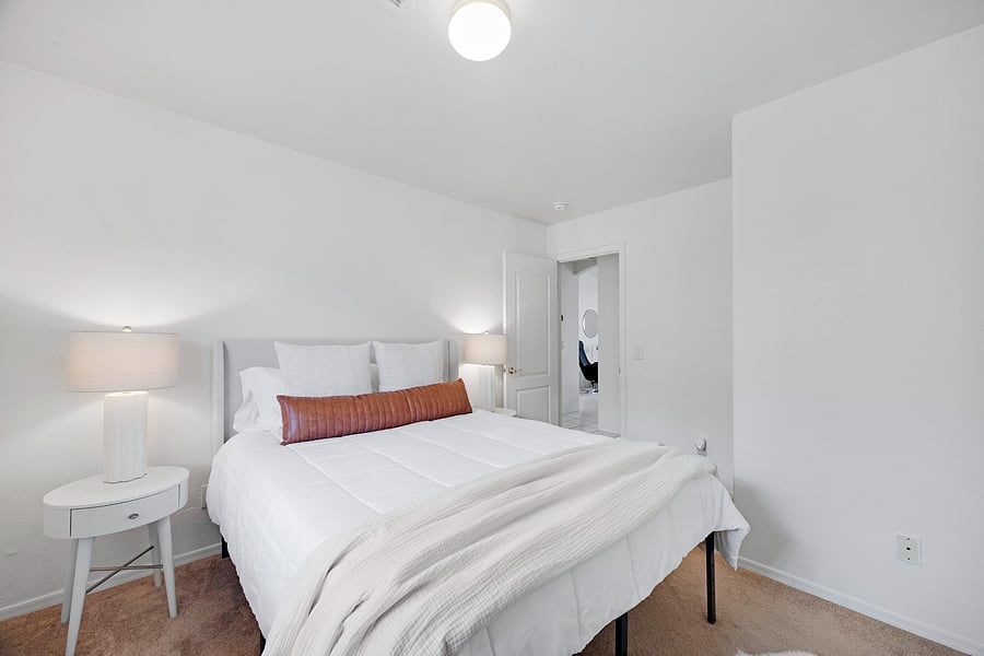 Comfortable queen bedroom with inviting furnishings, offering a restful retreat for additional guests or family members.
