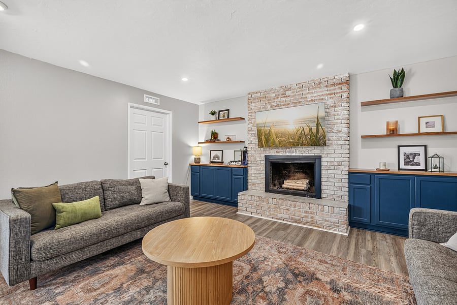 Comfortable living room seating and a decorative fireplace feature; fireplace is not available for guest use.