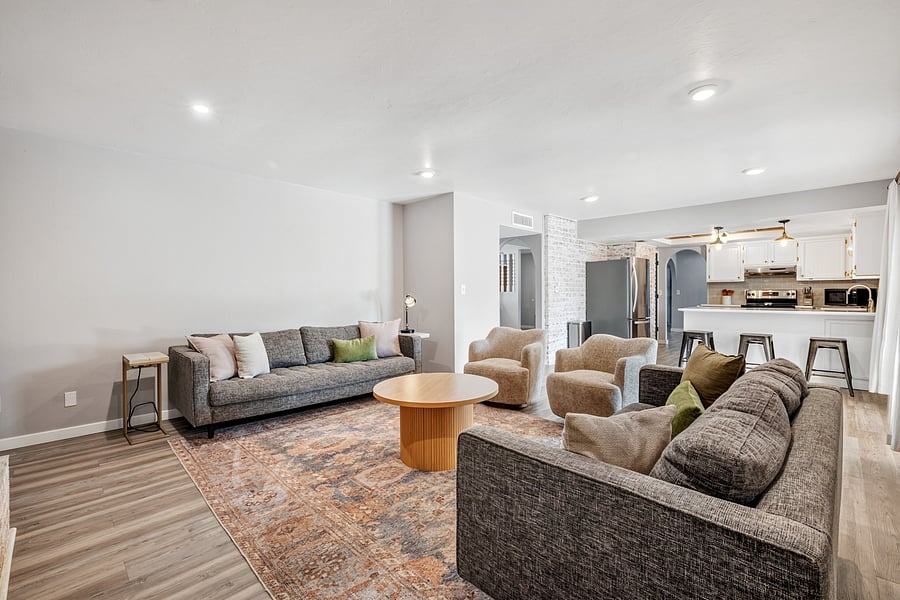 Spacious, comfortably furnished living room with ample seating for relaxing after work or spending time together.