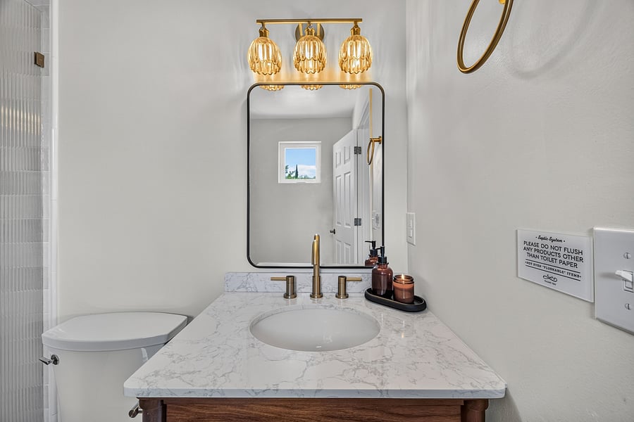 Primary bathroom vanity and mirror offer a dedicated space to get ready each day.