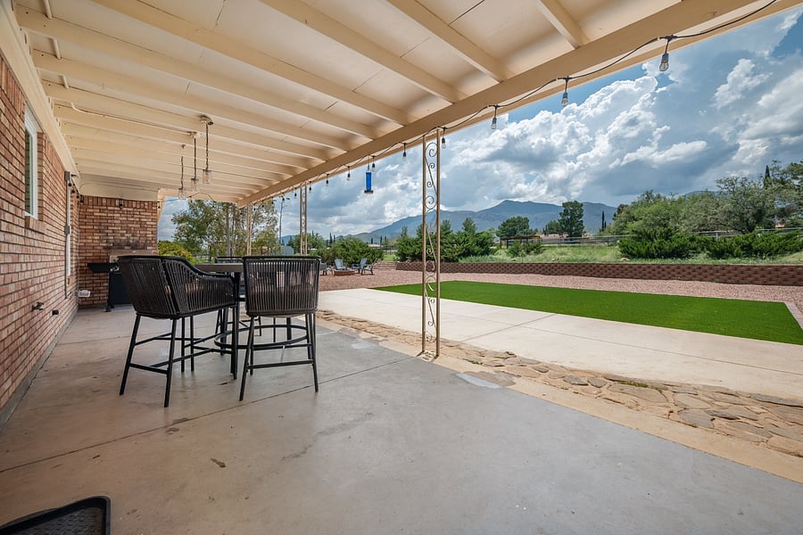 Covered patio seating offers a comfortable place to enjoy meals outside and take in the mountain scenery.