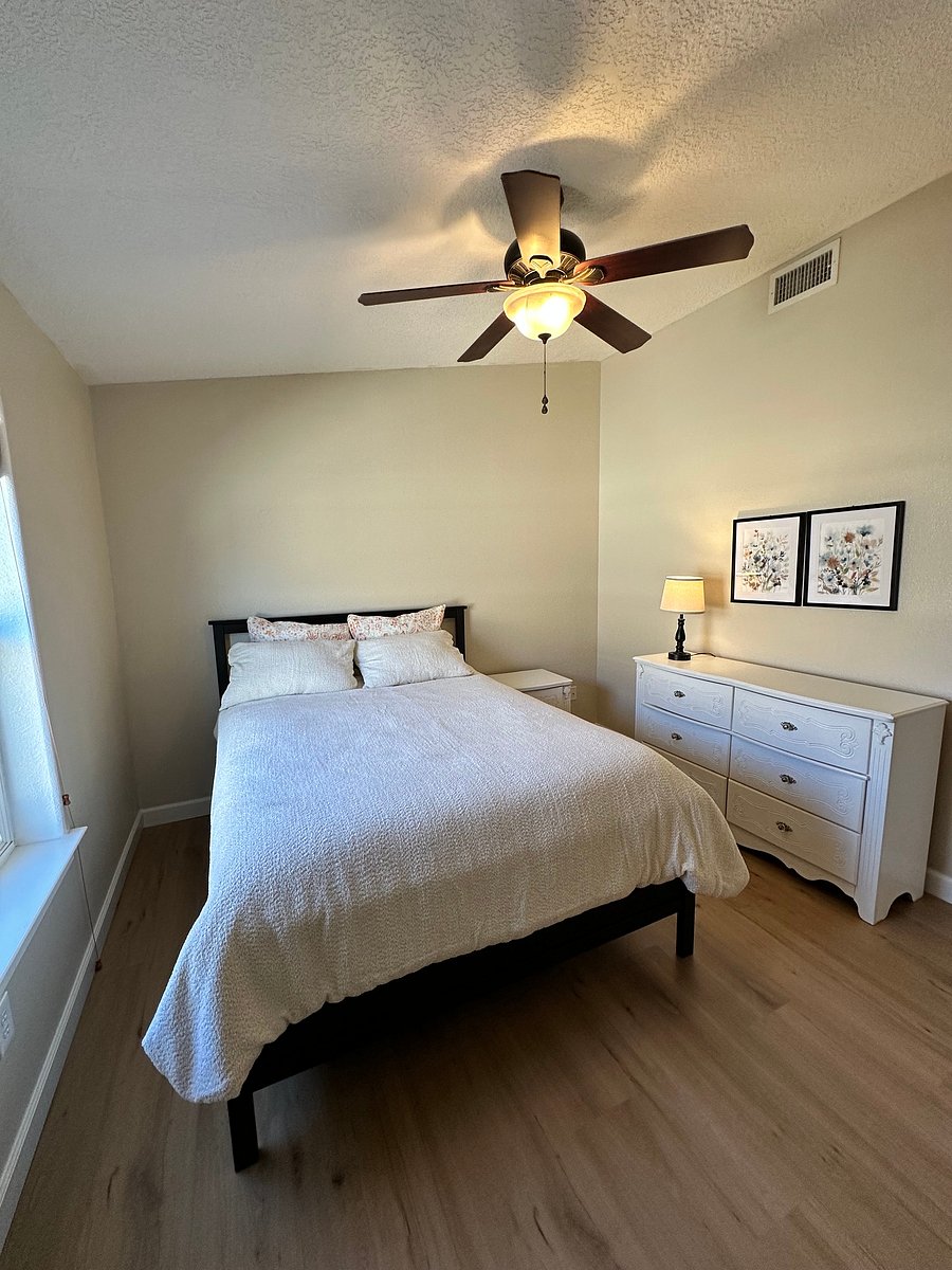2nd bedroom with a queen bed, nightstand and dresser. Not shown is a large closet. The lamp also has space for charging 2 devices. Note: there is a ceiling fan in each bedroom.