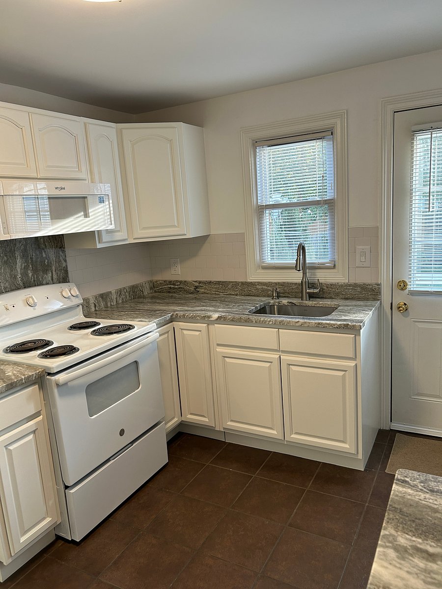 Kitchen with view to back yard and back door access to patio.
