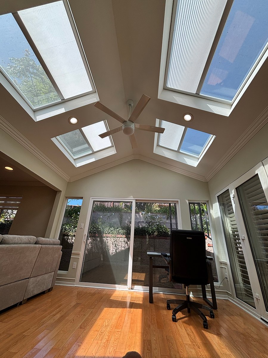 sun room with remote operated four retractable shades on roof