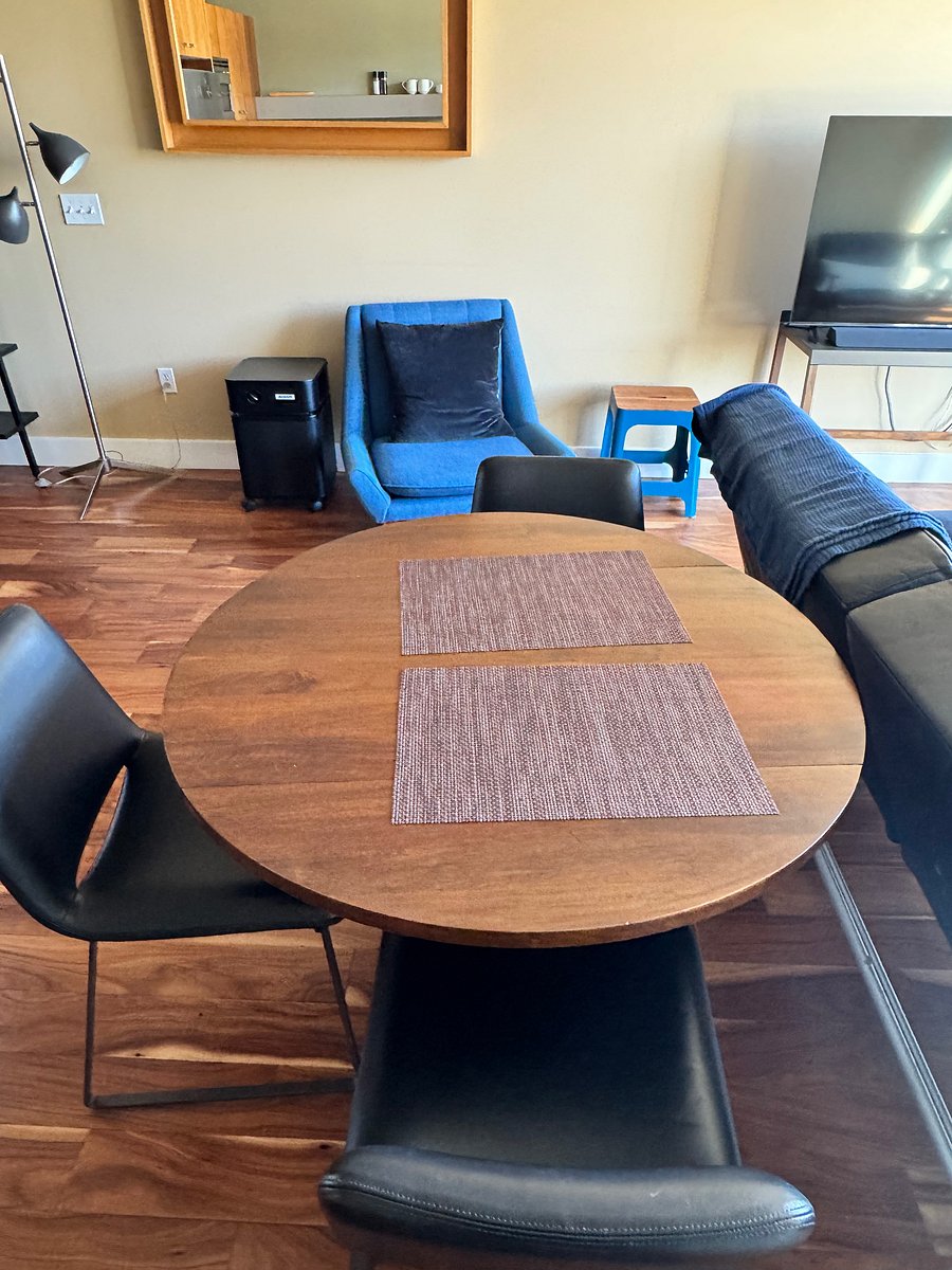 Current layout of folding sided round West Elm kitchen table, behind couch in kitchen area. Chilewich placemats.