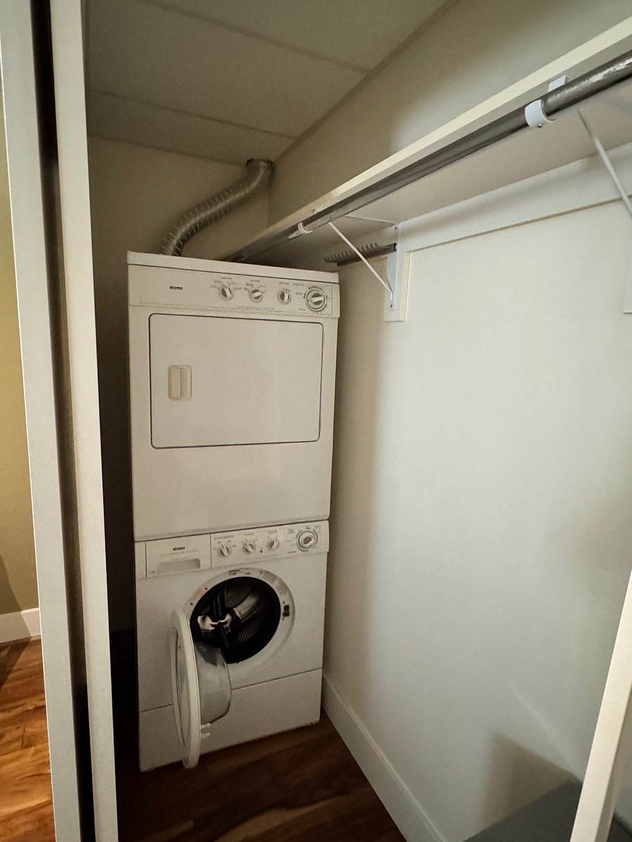 In unit washer and dryer located in bedroom closet.