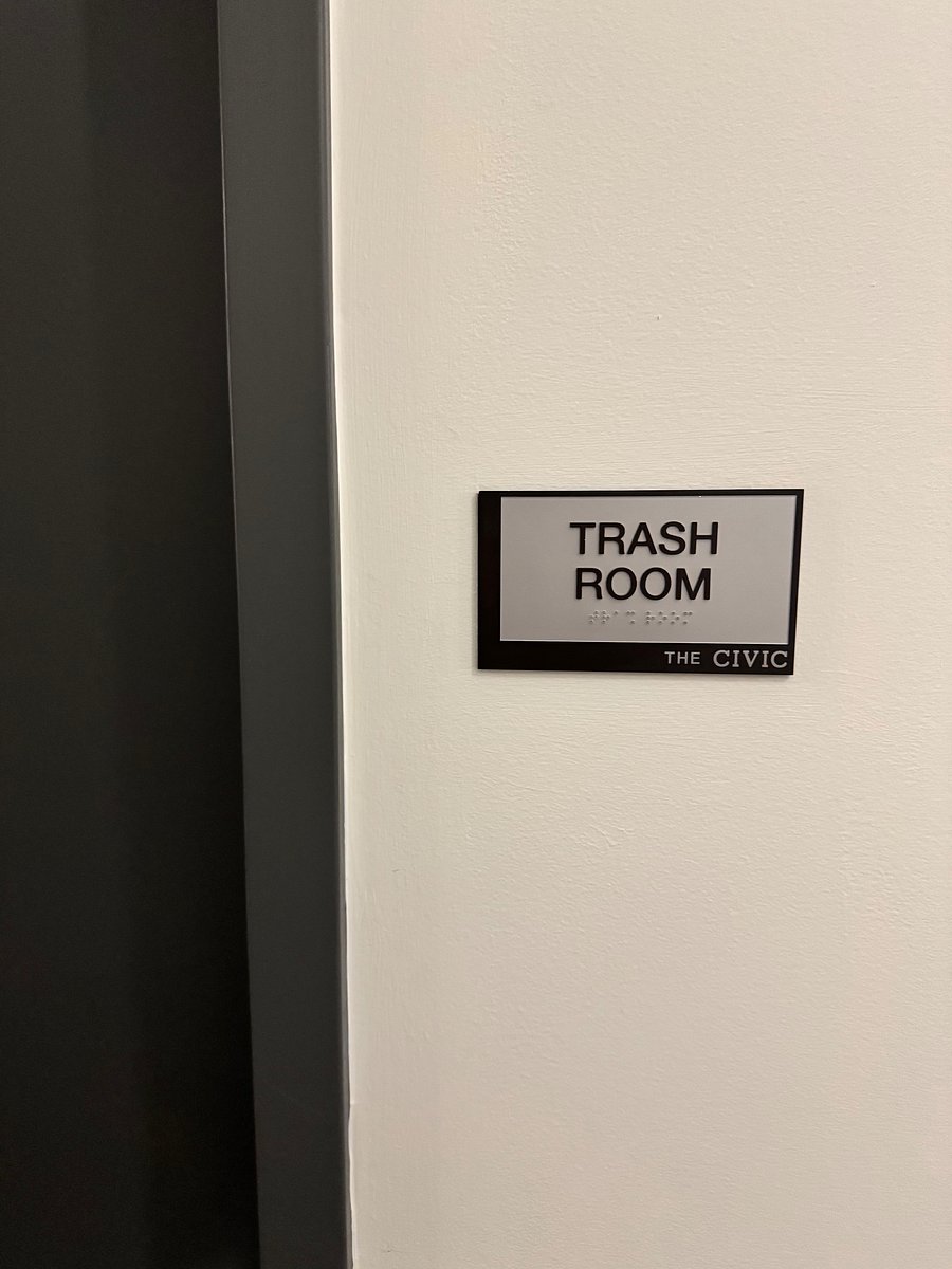 Trash room in exterior hallway.