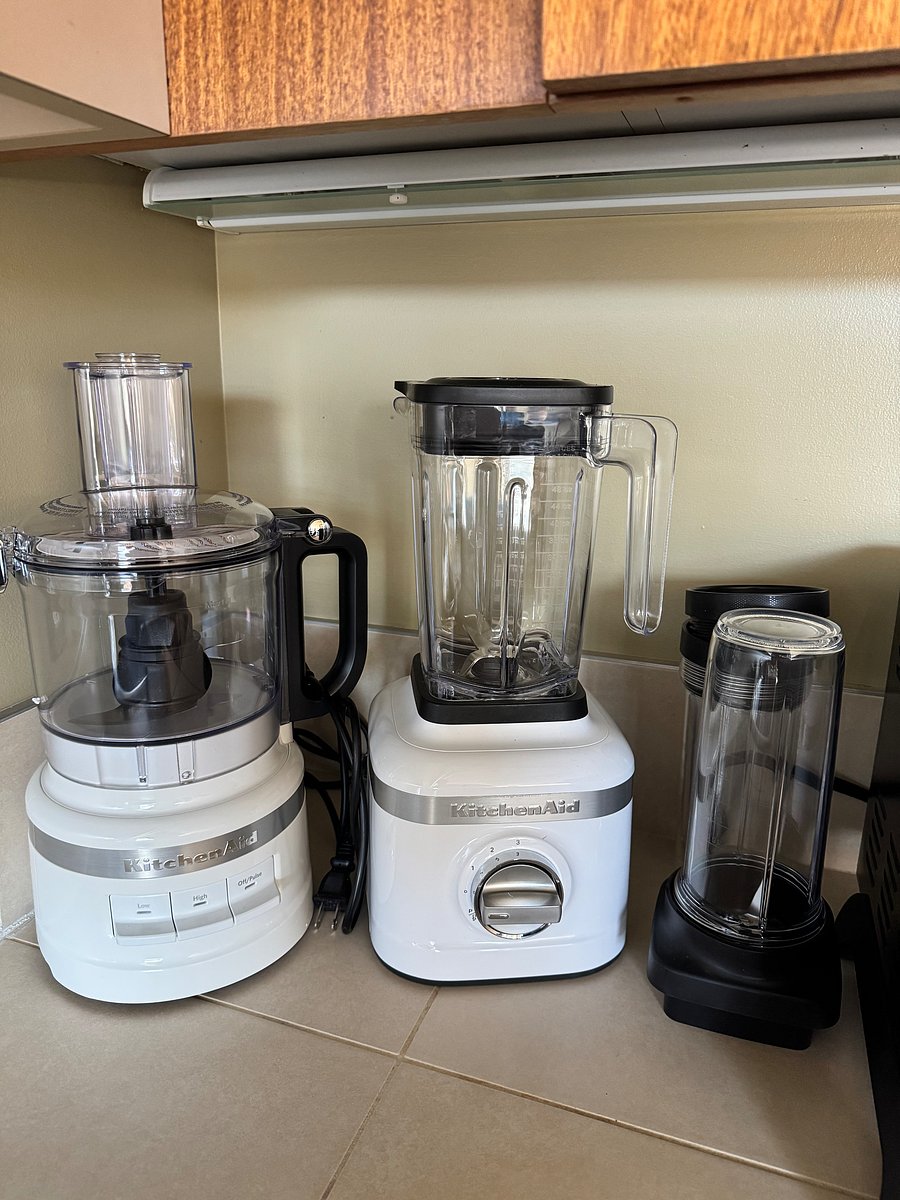 New Kitchen Aid food processor and Kitchen Aid blender with utility pieces.