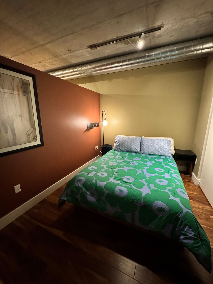 Marimekko comforter and sheets. The condo has all new linens. Queen bed with Componibili classic round storage unit from Kartell, plus Blu Dot shelving and marble-based dimmable lighting.