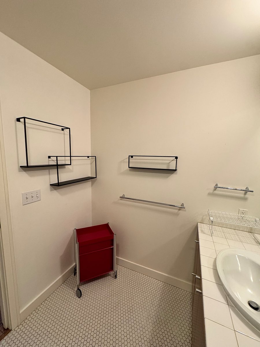 Bathroom shelving and rolling utility cart.