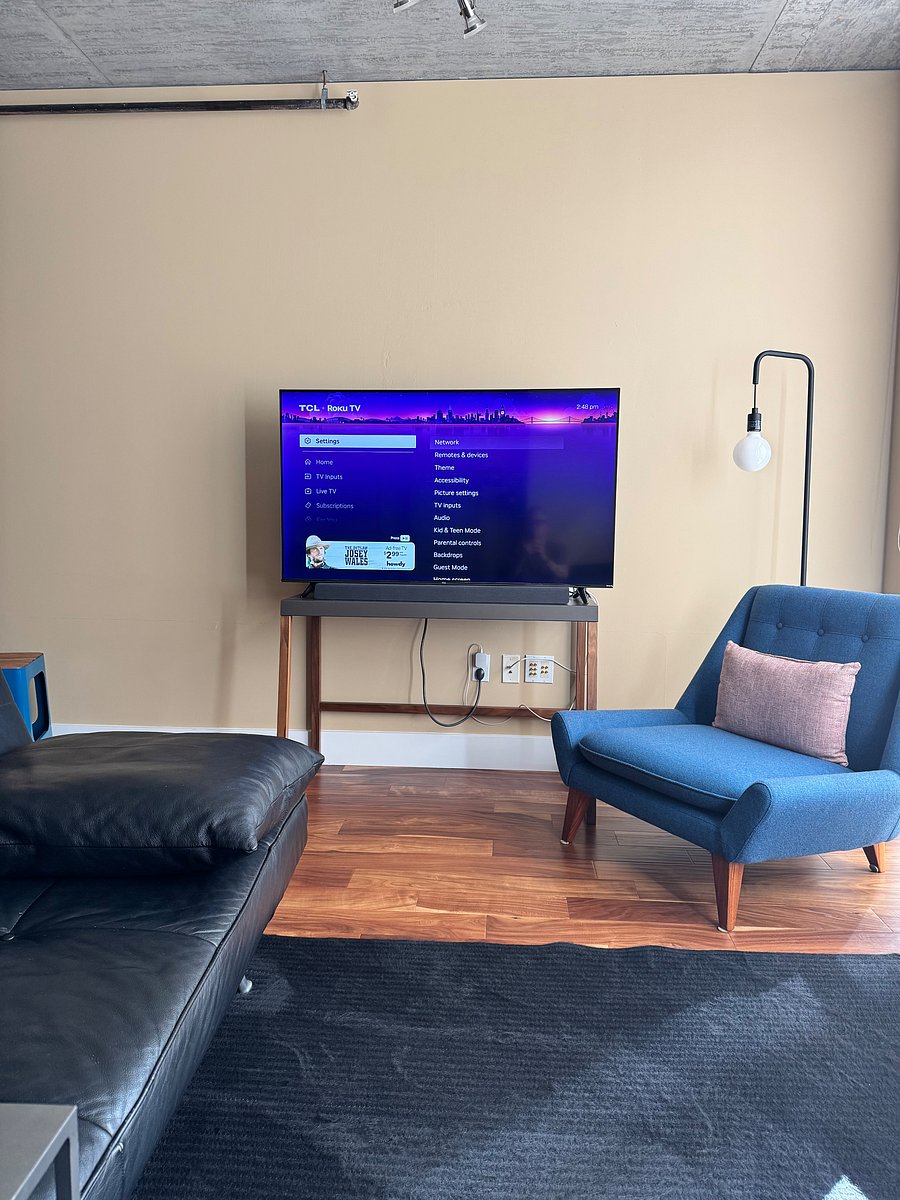 View of television from loveseat.
