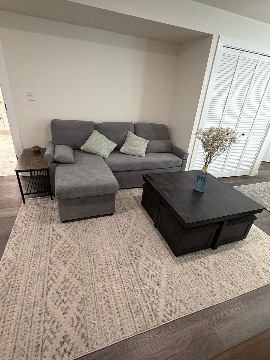 Your lounge space! The couch folds out into a queen bed if needed, and the ottomans under the coffee table pull out for extra storage, footrests, or extra seats. We've even included a deck of cards!