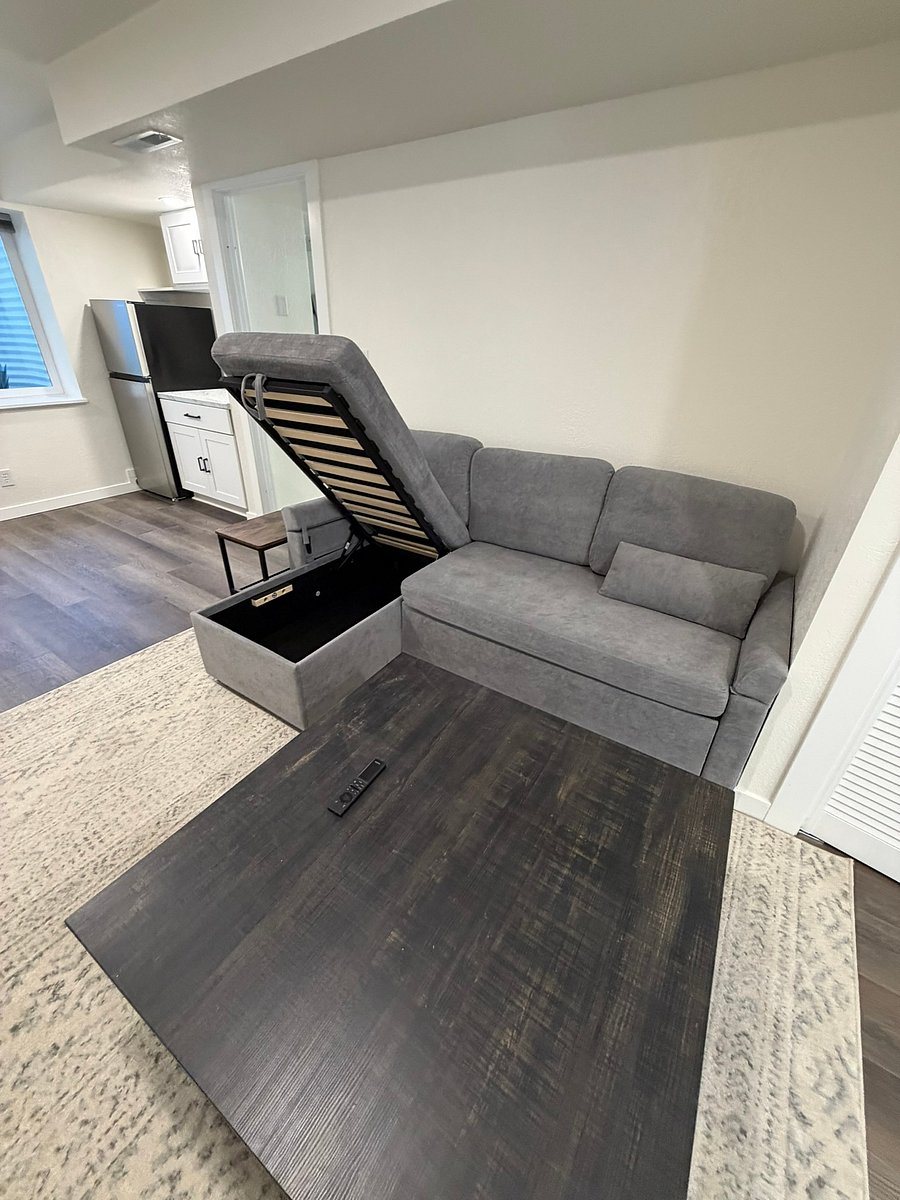The couch opens up for extra storage and folds out into a queen bed. If you have a guest visiting, we're happy to provide extra bedding on request!
