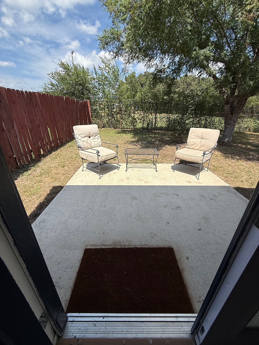 Backyard seating area. Also has BBQ grill.