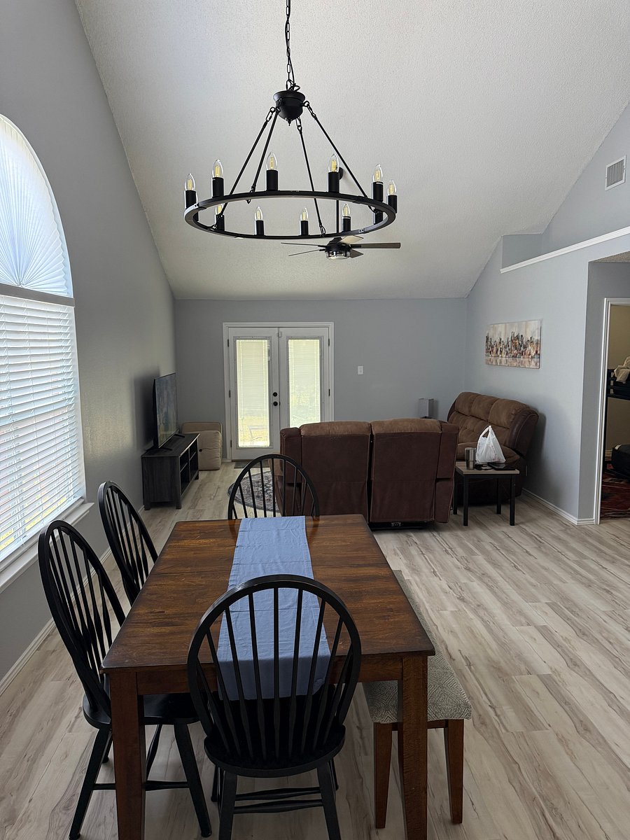Dining area and living room. Double doors lead to fenced backyard.