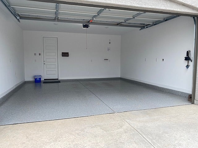 Two car garage with ev charger, epoxy floor and remote control openers.