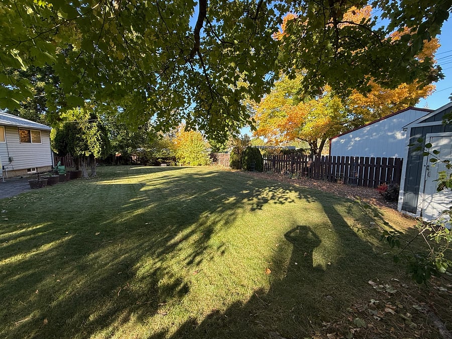 Oversized, fully fenced backyard with storage, mature landscape
