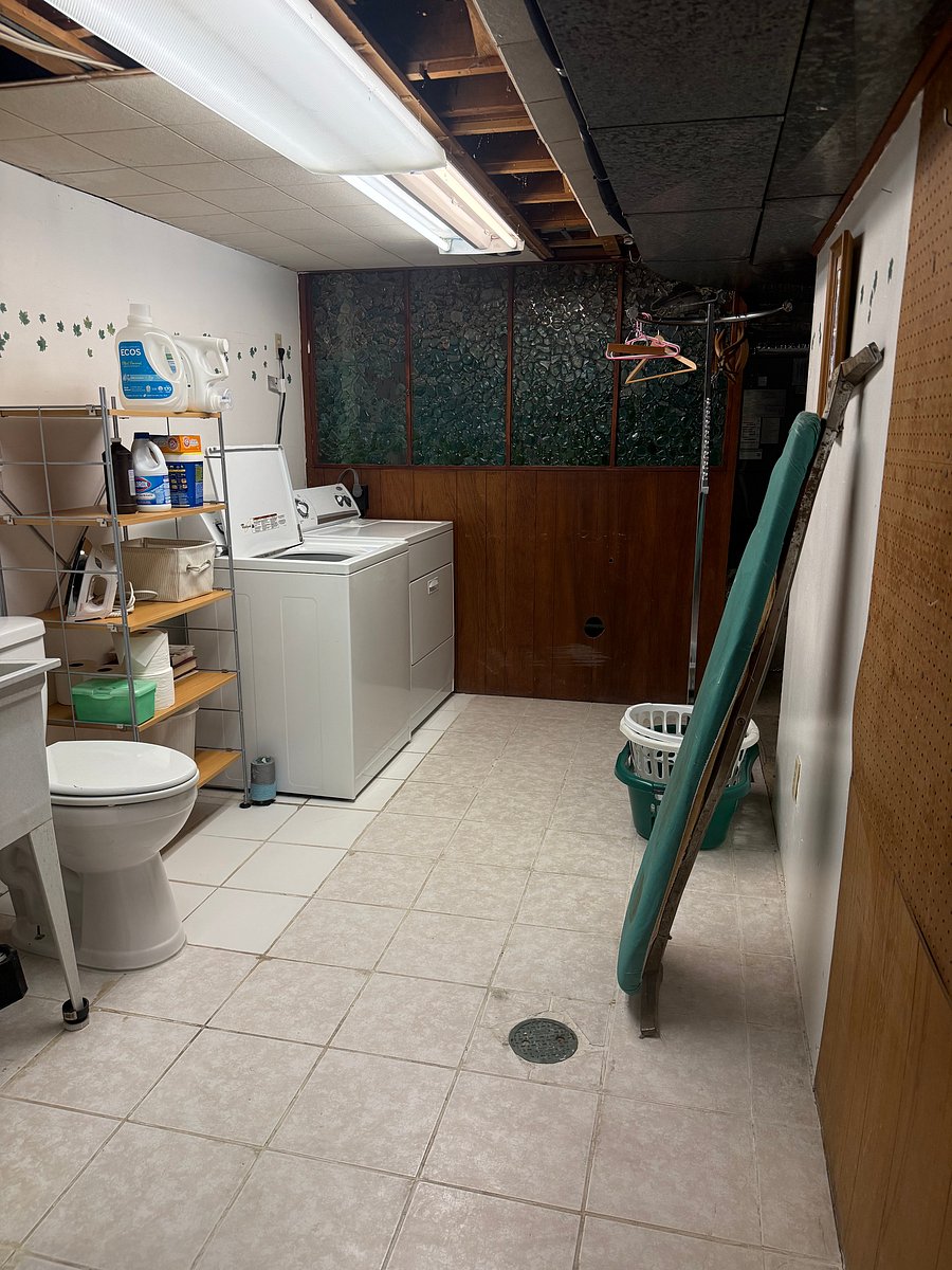 Basement 0.5 bath with full washer/dryer, ironing board, etc.