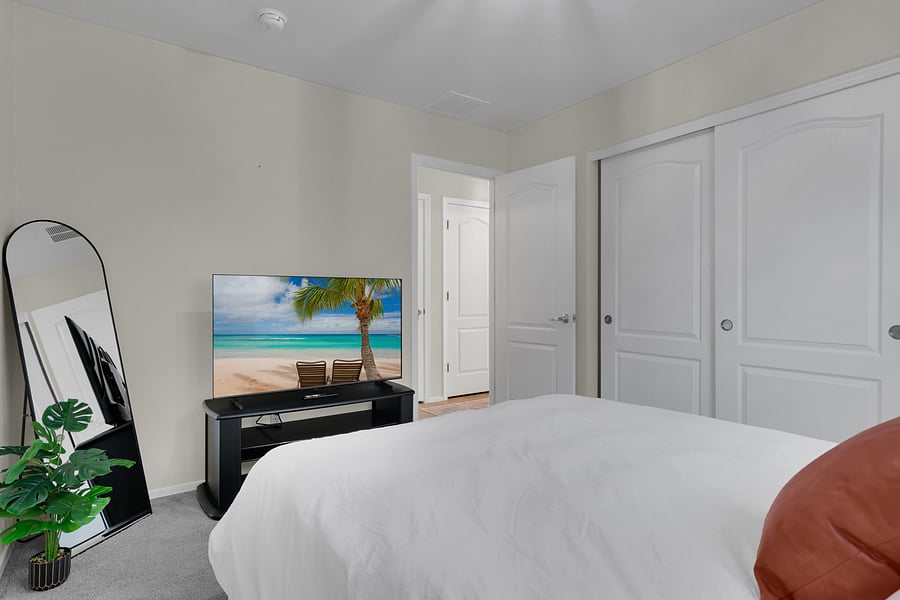 Comfortable, restful main floor bedroom with cozy bedding and a smart TV for relaxing nights in. Lamps have USB/USB-C ports.