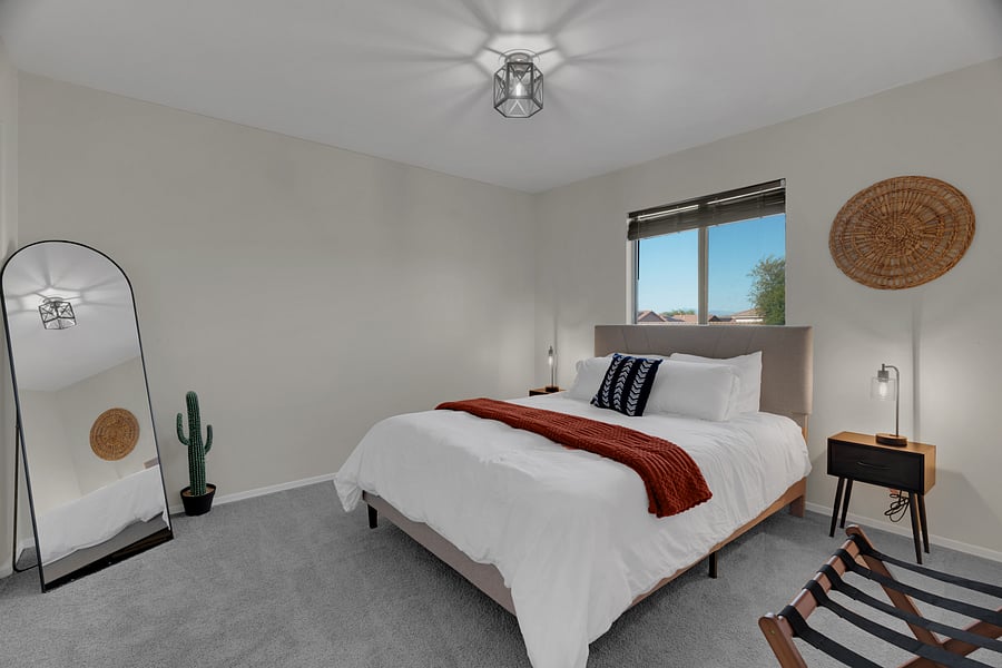 Cozy, thoughtfully styled bedroom with soft linens and natural light. Lamps have USB/USB-C ports