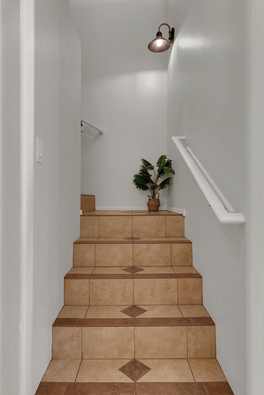 Bright, clean stairway connecting living spaces and bedrooms.