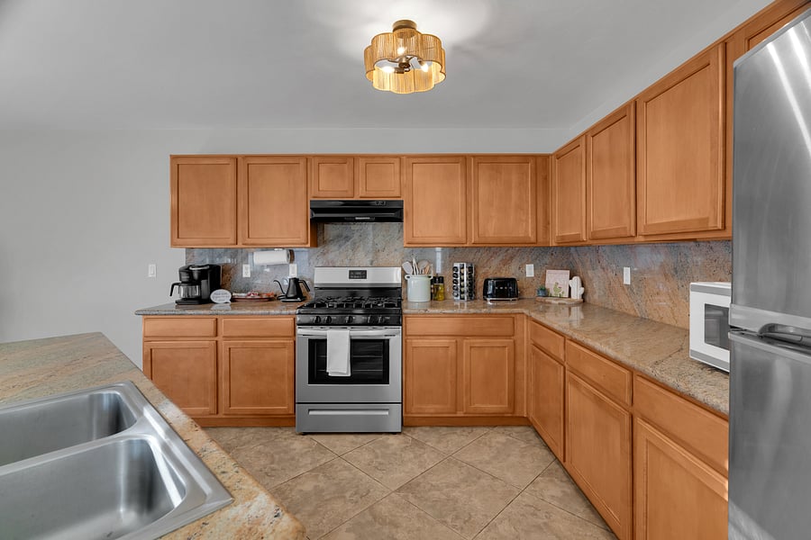 Cook with ease in this well-stocked kitchen featuring full-size appliances and ample workspace.