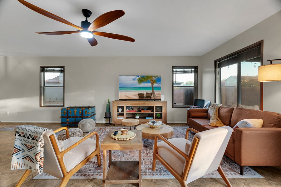 Thoughtfully designed space featuring warm tones, comfy seating, and a smart TV