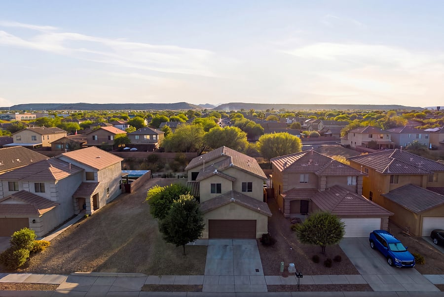 Serene neighborhood with desert landscaping and picturesque sunset views.