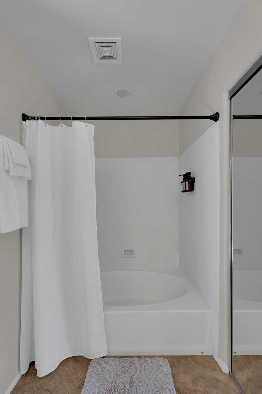 Clean master bathroom, spacious tub/shower combo-perfect for winding down after a long day.