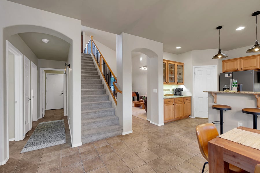 An open, airy floor plan flows from the kitchen and dining area to the living room and staircase, perfect for gathering together.