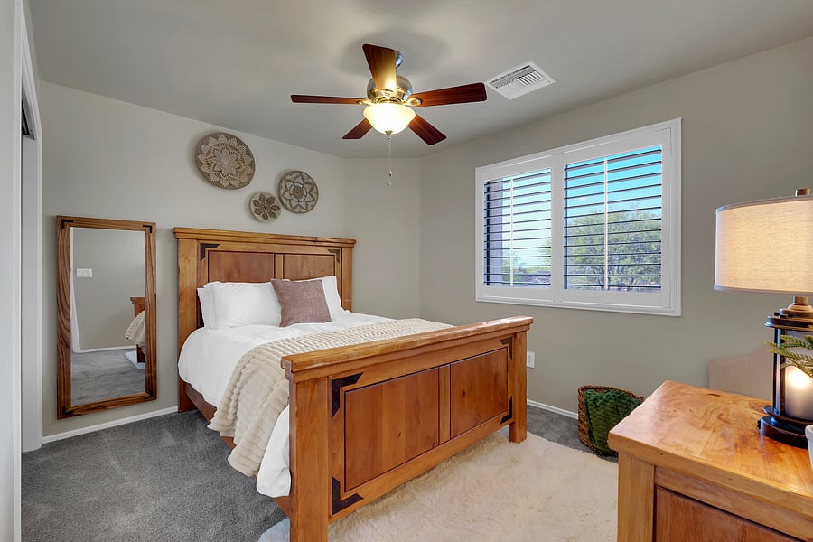 Thoughtfully designed for restful nights, with a ceiling fan, full-length mirror, and soft shag rug underfoot.