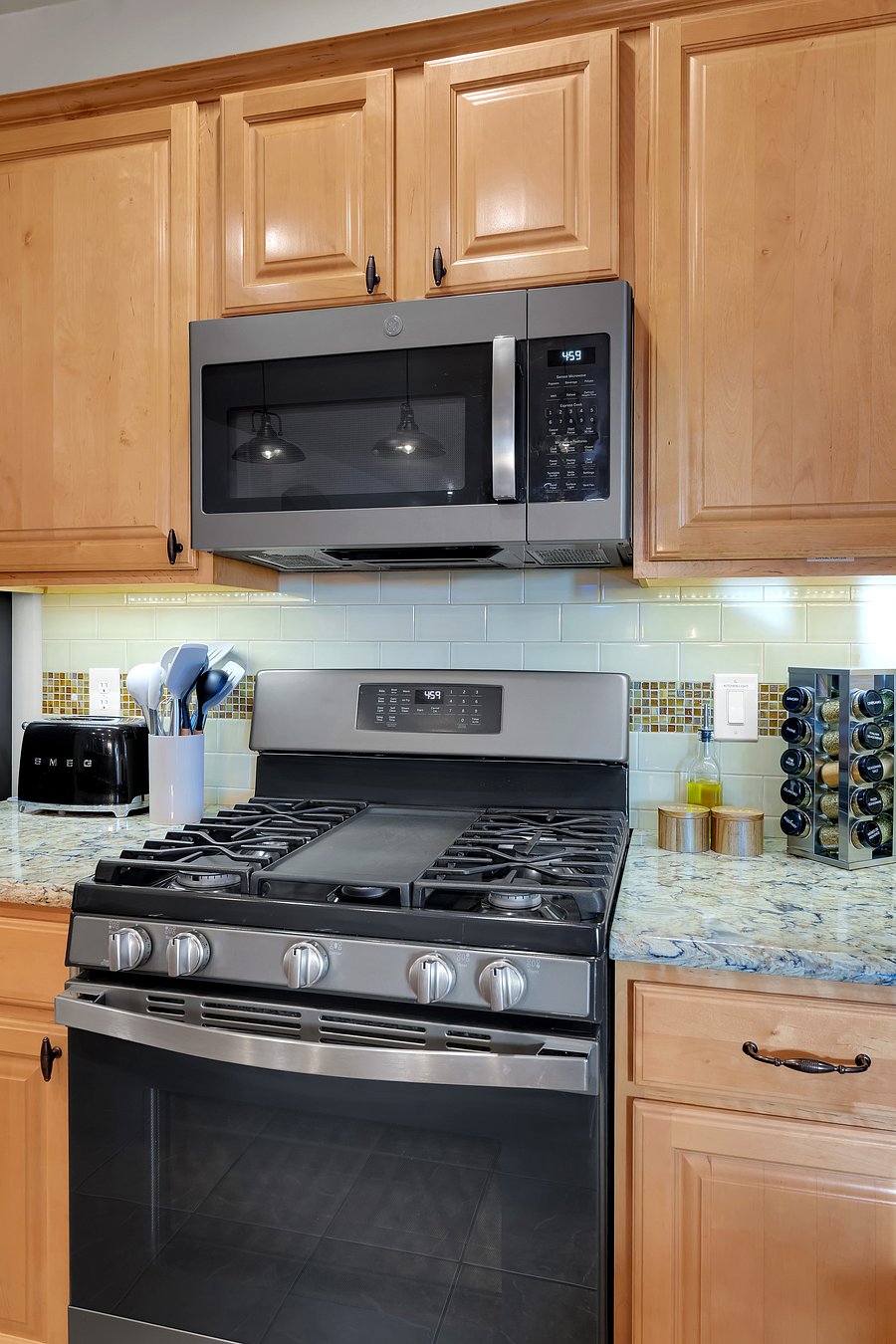 Cook with ease on the five-burner gas range with built-in griddle, plus a stocked spice rack and everyday essentials.