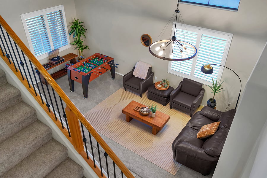 Thoughtfully designed for fun and relaxation: plush lounge seating, game time with foosball, and vinyl vibes under a statement chandelier.