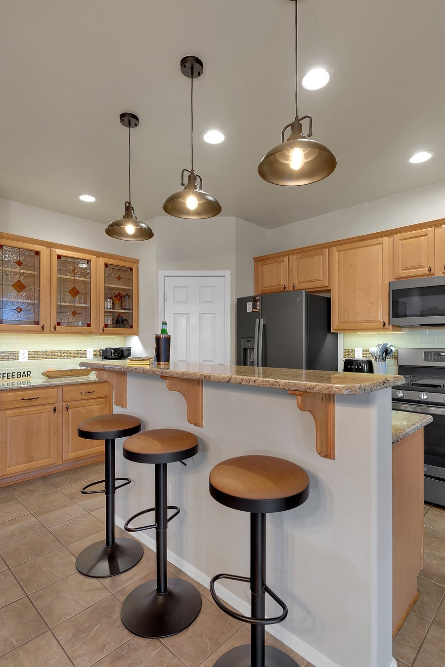 Gather for morning coffee or late-night snacks at this inviting bar with comfy seating for three.