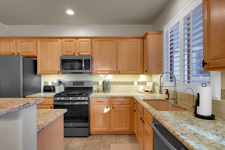 A fully stocked kitchen with granite countertops, gas range, and modern appliances, perfect for cooking up family favorites.