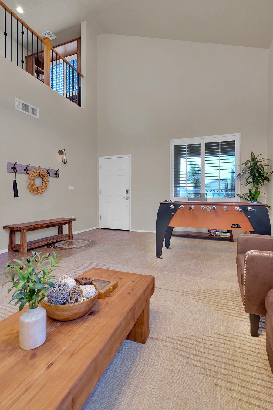 Step inside to soaring ceilings and a bright, open welcome, with easy keyless entry, a cozy entry bench, and game time steps away.